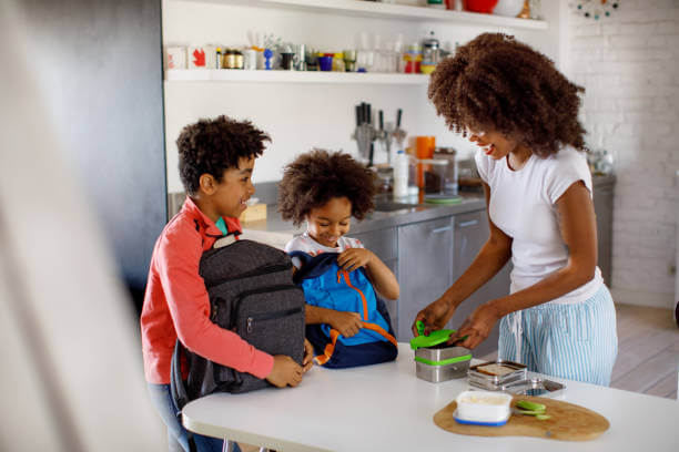 A Mother Packing School Lunch for Her Kids