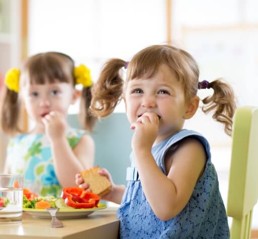 Children eating food from stainless steel lunch boxes