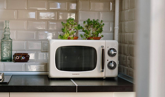 Silver Microwave Oven on White Wooden Cabinet