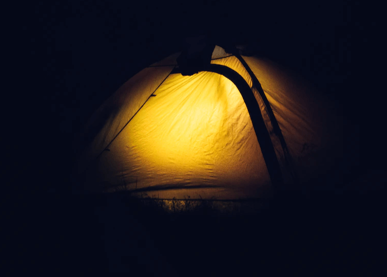 a tent displayed with flashlight on