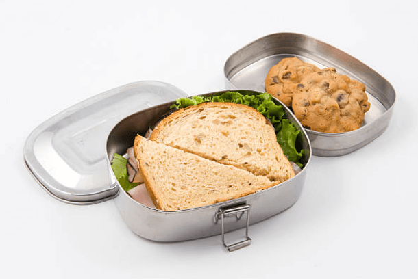 stainless steel container with sandwich and cookies