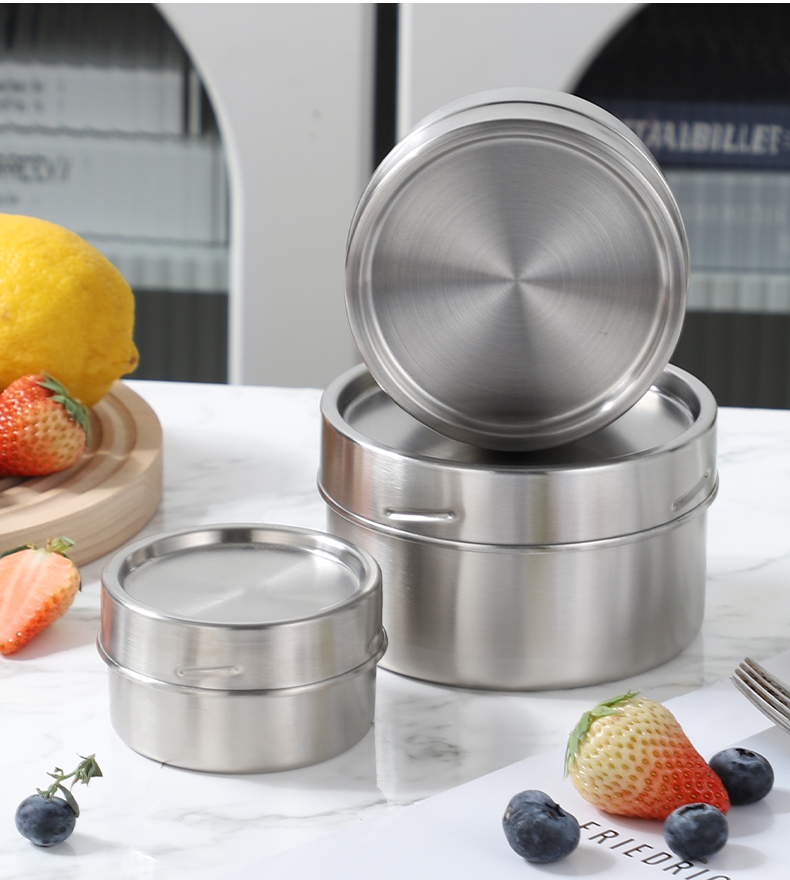 Full set overview — stainless steel screw top containers with fresh fruit and utensils flat lay